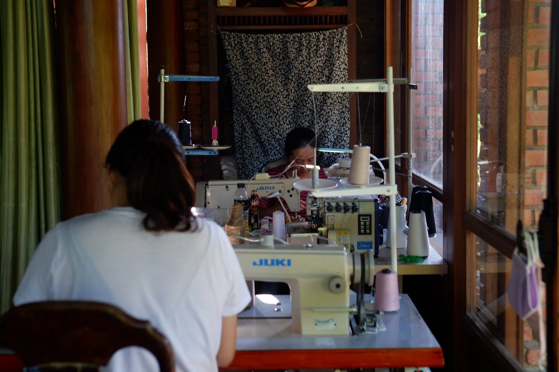 Hoi An tailor sewing custom clothing in a local tailoring workshop