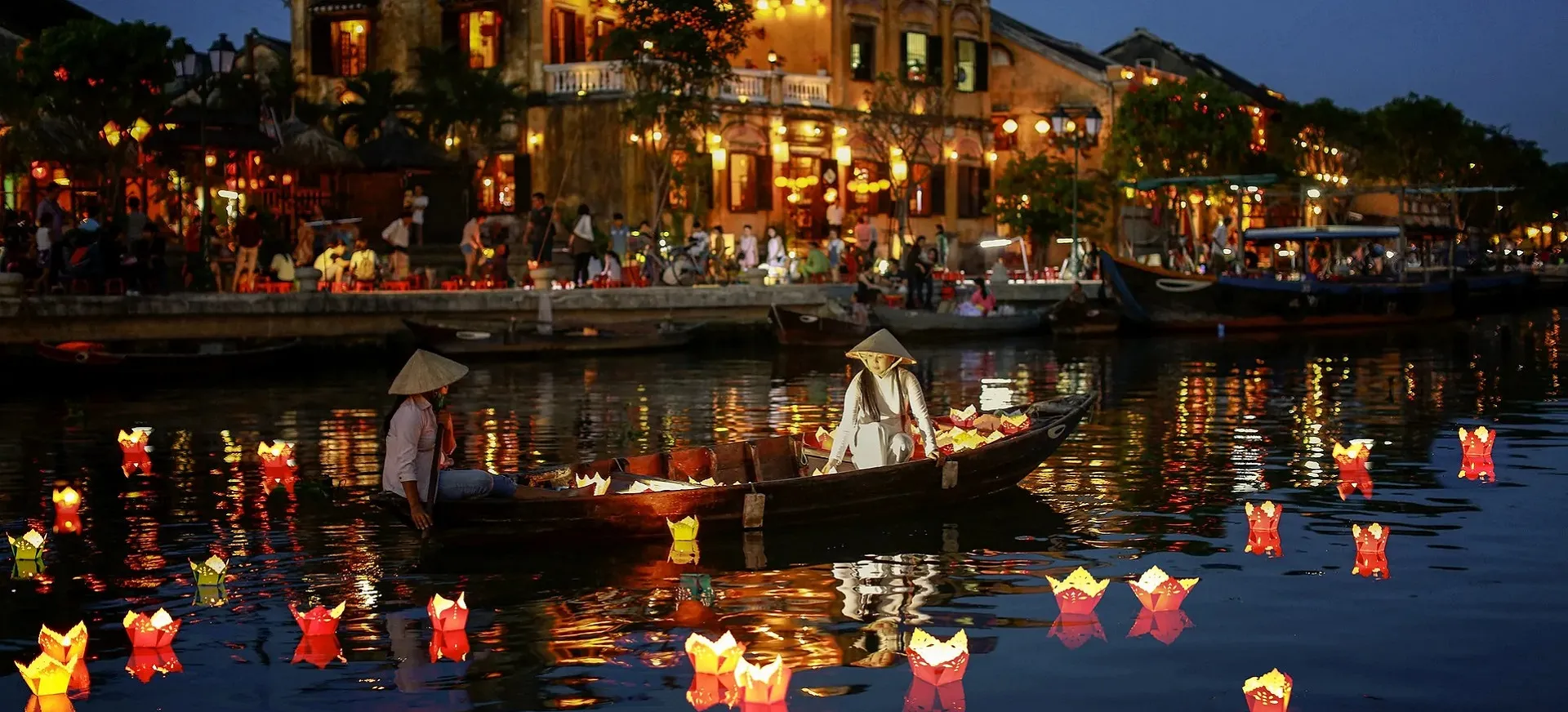 Glowing candles floating on the Hoai River in Hoian